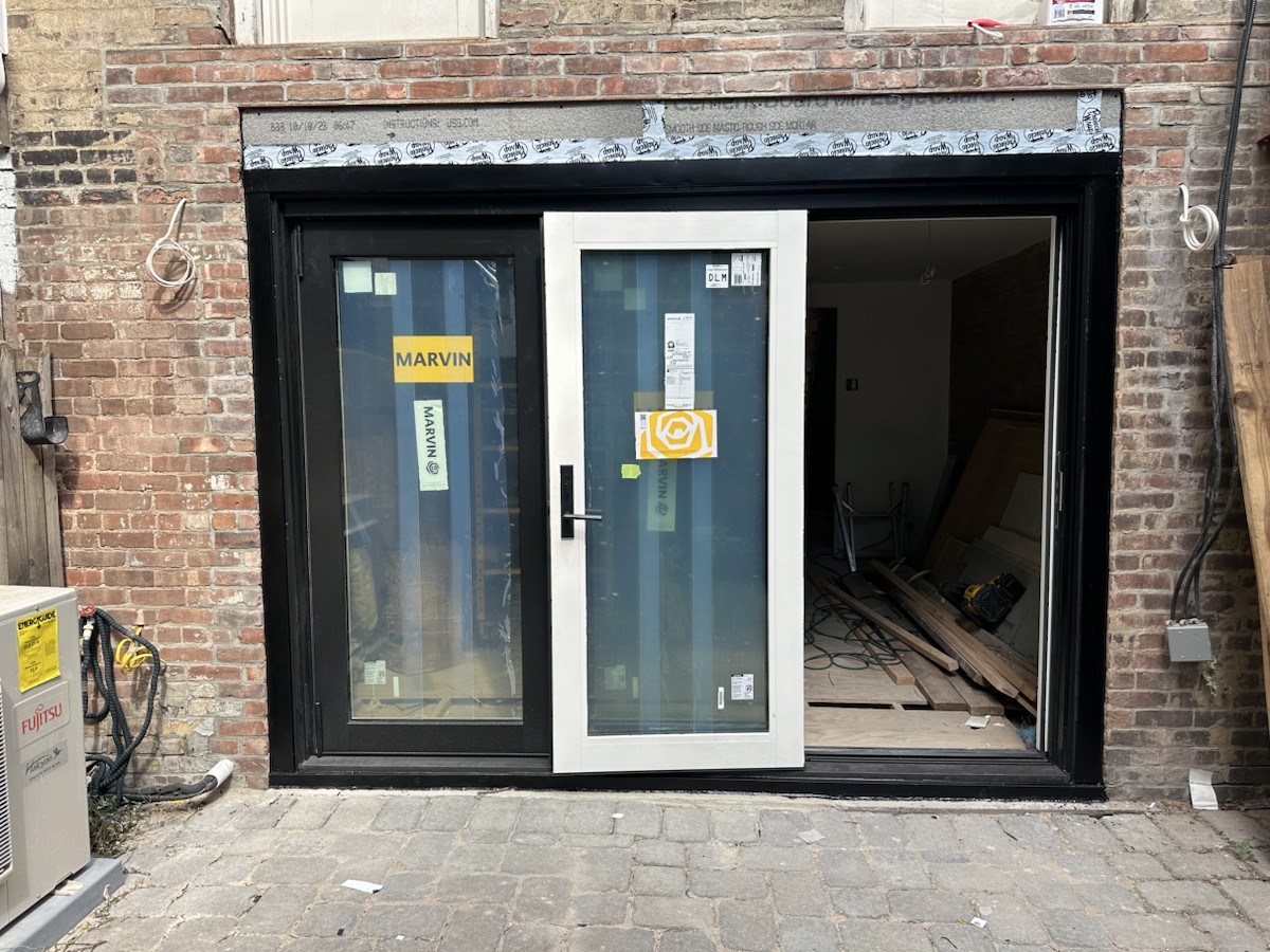 Project step 3: first folding-door panels positioned in the opening