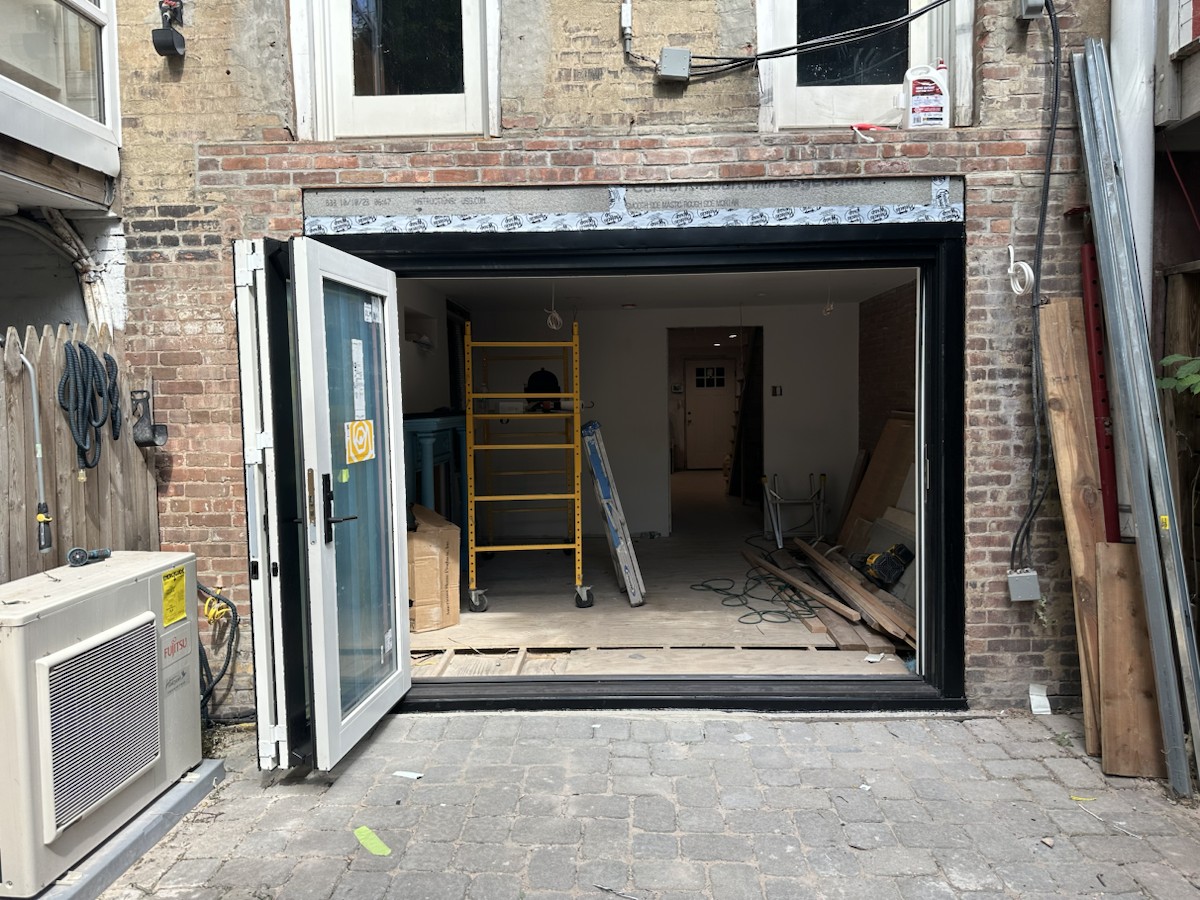 Project step 5: folding-door panels fully opened from the exterior